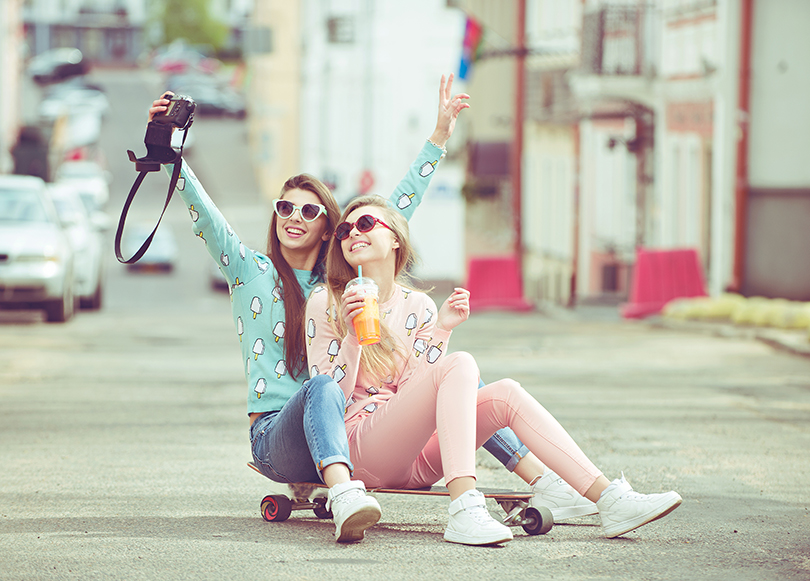 two_girls_taking_pictures_of_themselves